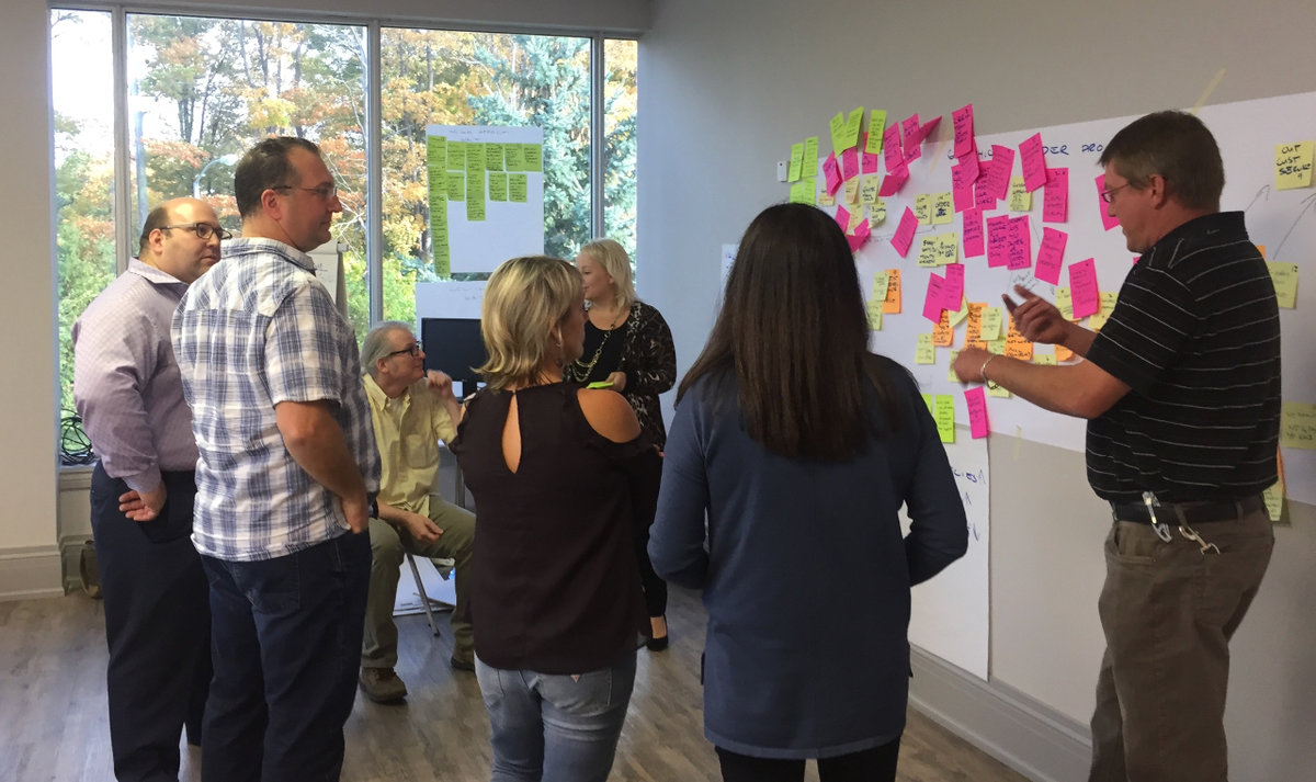 Group of leaders in a leadership training program discussing plan of action.